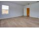 This bedroom features hardwood floors and a window providing natural light for a bright, airy atmosphere at 2228 Hannah S Way, Dunedin, FL 34698