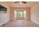 Spacious bedroom featuring a bay window, ceiling fan, and neutral walls complemented by light hardwood flooring at 2228 Hannah S Way, Dunedin, FL 34698