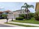 Two-story home with a three-car garage, well-kept lawn and mature landscaping at 2228 Hannah S Way, Dunedin, FL 34698