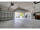 Spacious three-car garage, featuring an open door and plenty of storage space at 2228 Hannah S Way, Dunedin, FL 34698