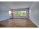 Living room with wood floors and lots of light coming in from exterior windows at 2228 Hannah S Way, Dunedin, FL 34698