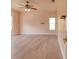 Main bedroom featuring a ceiling fan and wood floors with peach color walls at 2228 Hannah S Way, Dunedin, FL 34698