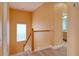 Stairwell with wood handrail and orange color walls and view to the upper floor at 2228 Hannah S Way, Dunedin, FL 34698