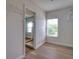 Walk-in Closet with wood floors, wire shelving, and window with exterior view at 2228 Hannah S Way, Dunedin, FL 34698