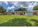A well-maintained backyard featuring a storage shed and a patio area with outdoor furniture at 2415 York N St, St Petersburg, FL 33710