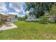 Spacious backyard featuring a large lawn, patio, and shed for outdoor storage at 2415 York N St, St Petersburg, FL 33710