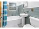 Bathroom with tile details, a pedestal sink, and a shower-tub combination at 2415 York N St, St Petersburg, FL 33710