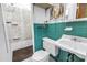 Vintage bathroom with shower, toilet, and sink, featuring unique tile work at 2415 York N St, St Petersburg, FL 33710