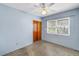 Well-lit bedroom with a ceiling fan, closet, and window providing natural light at 2415 York N St, St Petersburg, FL 33710