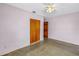 Minimalist bedroom with closet, wood door, and neutral walls; plenty of sunlight at 2415 York N St, St Petersburg, FL 33710