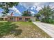 Charming single-story home with a well-manicured lawn and an American flag at 2415 York N St, St Petersburg, FL 33710