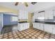 Bright kitchen with white cabinets, stainless steel sink, and unique tile flooring at 2415 York N St, St Petersburg, FL 33710