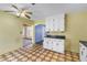 Spacious kitchen with white cabinets, black countertops, and decorative tiled flooring at 2415 York N St, St Petersburg, FL 33710