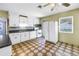 Open kitchen with white cabinets, stove, refrigerator, and a large window for natural light at 2415 York N St, St Petersburg, FL 33710