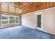 Comfortable living room with a wooden ceiling, windows with natural light, and an exterior door at 2415 York N St, St Petersburg, FL 33710