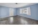 Bright living room featuring polished terrazzo floors, white trim, and blue walls at 2415 York N St, St Petersburg, FL 33710