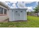 Backyard shed providing additional storage space; featuring secure double doors and decorative lamps at 2415 York N St, St Petersburg, FL 33710