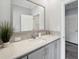 Bathroom featuring gray cabinets, a white marble countertop and a large mirror at 246 Gretna St, Port Charlotte, FL 33954