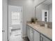 Bathroom featuring gray cabinets, a white marble countertop and a doorway to a toilet at 246 Gretna St, Port Charlotte, FL 33954