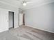 Neutral bedroom featuring a ceiling fan, a closet, and a gray carpet at 246 Gretna St, Port Charlotte, FL 33954