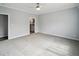 Open bedroom with a light gray carpet, a ceiling fan and gray paint with an ensuite bathroom at 246 Gretna St, Port Charlotte, FL 33954