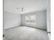 Bright bedroom with large windows, a ceiling fan, soft carpet and light gray paint at 246 Gretna St, Port Charlotte, FL 33954