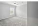 Neutral bedroom featuring a ceiling fan, a large window and gray carpet at 246 Gretna St, Port Charlotte, FL 33954