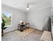 Neutral bedroom featuring a ceiling fan, a large window and a desk in the corner at 246 Gretna St, Port Charlotte, FL 33954
