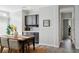 Bright dining room features a wooden table with seating and access to a hall with gray laminate flooring at 246 Gretna St, Port Charlotte, FL 33954