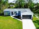 Inviting single-story home with well-kept lawn and an attached garage, offering comfortable suburban living at 246 Gretna St, Port Charlotte, FL 33954