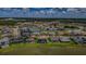 Beautiful aerial view of a lakeside community with well-manicured lawns, sparkling water, and attractive homes with pools at 29038 Picana Ln, Wesley Chapel, FL 33543