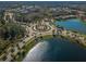 Aerial view of a community roundabout with landscaping and pond views at 29038 Picana Ln, Wesley Chapel, FL 33543