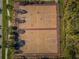 Aerial view of community basketball courts bordered by sidewalks and trees at 29038 Picana Ln, Wesley Chapel, FL 33543