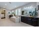 Bright bathroom boasts dual sinks, large mirror, soaking tub, and access to large walk-in closet at 29038 Picana Ln, Wesley Chapel, FL 33543