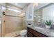 Bathroom with glass enclosed shower, granite vanity, and decorative mirror at 29038 Picana Ln, Wesley Chapel, FL 33543