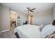 Neutral bedroom featuring a ceiling fan, carpet flooring, and a walk-in closet for ample storage at 29038 Picana Ln, Wesley Chapel, FL 33543