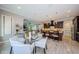 Breakfast nook with a glass table and white chairs next to the kitchen and a large window at 29038 Picana Ln, Wesley Chapel, FL 33543