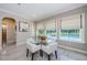 A bright breakfast nook with views of the pool, with lots of natural light coming in through large windows at 29038 Picana Ln, Wesley Chapel, FL 33543