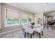 Bright breakfast nook features views of the pool and outdoor area through large windows at 29038 Picana Ln, Wesley Chapel, FL 33543