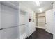 Spacious walk-in closet with custom shelving, drawers, hanging rods, and dark wood-look floors at 29038 Picana Ln, Wesley Chapel, FL 33543