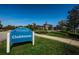 Attractive blue sign for the Estancia at Wiregrass Clubhouse set on a grassy lawn with the building in the background at 29038 Picana Ln, Wesley Chapel, FL 33543
