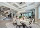 Elegant dining room with coffered ceilings, chandelier, and staircase visible from the doorway at 29038 Picana Ln, Wesley Chapel, FL 33543