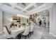 Sophisticated dining room featuring coffered ceilings, chandelier, and seamless flow into the home at 29038 Picana Ln, Wesley Chapel, FL 33543