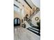 Grand foyer with soaring ceilings, statement lighting, staircase with decorative iron railing, and tile flooring at 29038 Picana Ln, Wesley Chapel, FL 33543