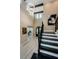 Elegant foyer with high ceilings, statement chandelier, staircase with iron railing, and tile flooring at 29038 Picana Ln, Wesley Chapel, FL 33543