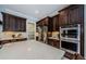 Kitchen area with dark cabinetry, stainless steel appliances, and a white countertop on the large kitchen island at 29038 Picana Ln, Wesley Chapel, FL 33543
