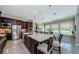 Spacious kitchen featuring a large island, stainless steel appliances, and a view of the backyard and pool at 29038 Picana Ln, Wesley Chapel, FL 33543