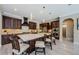 Gourmet kitchen featuring a large island, stainless steel appliances, and beautiful cabinetry with a dine-in area at 29038 Picana Ln, Wesley Chapel, FL 33543