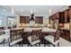 Kitchen with a large island, dark wood cabinets, stainless steel appliances, and a view of the open living area at 29038 Picana Ln, Wesley Chapel, FL 33543