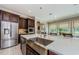 Kitchen with stainless steel appliances, a large island with a sink, and a view of the backyard at 29038 Picana Ln, Wesley Chapel, FL 33543